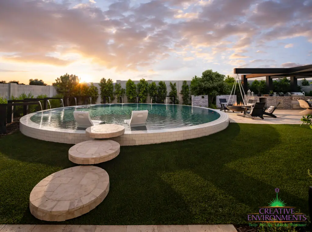 Custom backyard design with circular steps into circular pool and artificial grass decking.