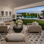 Custom backyard design with deco-tile patio, multiple seating areas and large metal planters.
