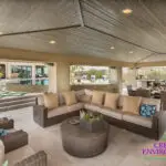 Custom backyard design with artificial turf pattern, zero-edge pool and outdoor entertainment area.