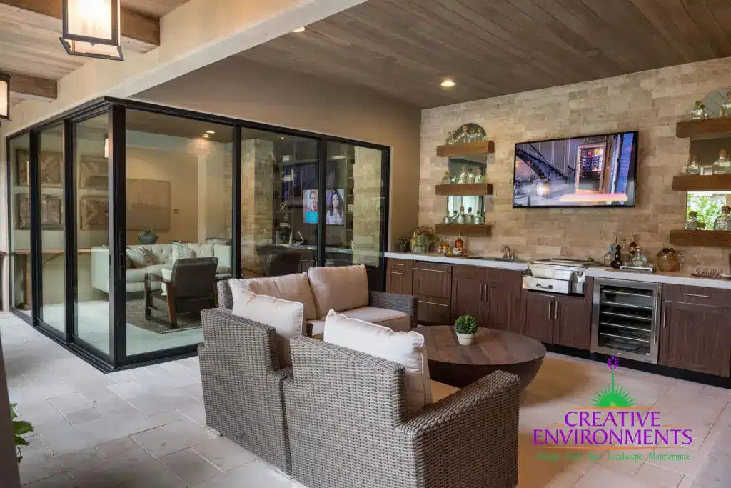 Custom backyard design with outdoor shelving, outdoor kitchen and multiple seating areas.