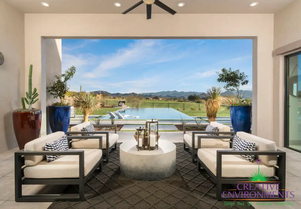 Custom backyard design with metal accents, large planters and zero edge pool with baja step.