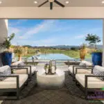 Custom backyard design with metal accents, large planters and zero edge pool with baja step.