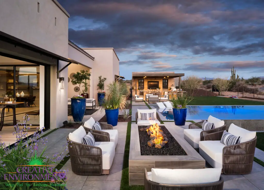 Custom backyard design with blue accents, shade structure and linear fire table.