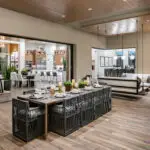 Custom backyard design with hanging seating, outdoor dining area and indoor/outdoor design fusion.