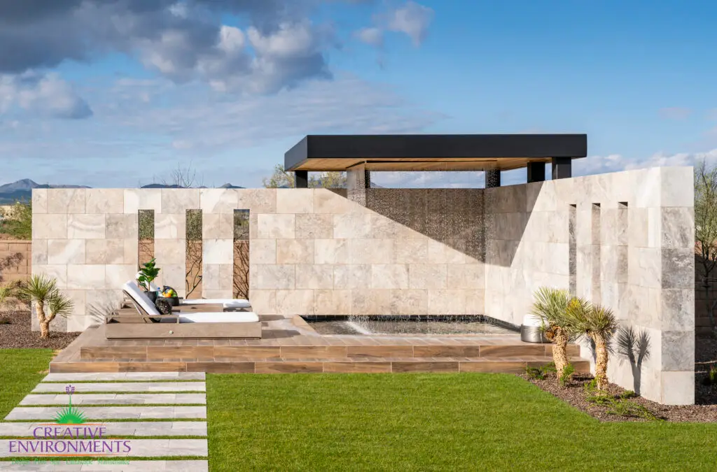 Custom backyard design with cantilevered rain curtain, multiple seating areas and raised, private spa.
