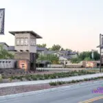 Custom community entrance with cantilevered planters, metal scupper water features and organized planting.