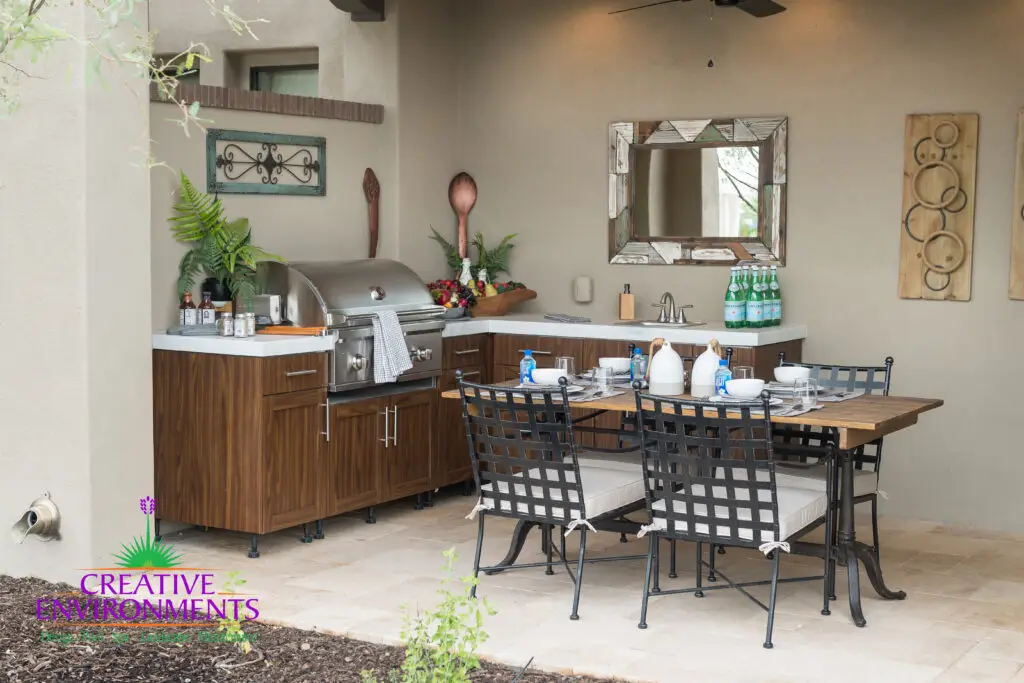 Custom backyard design with outdoor BBQ, outdoor dining area and organized planting.