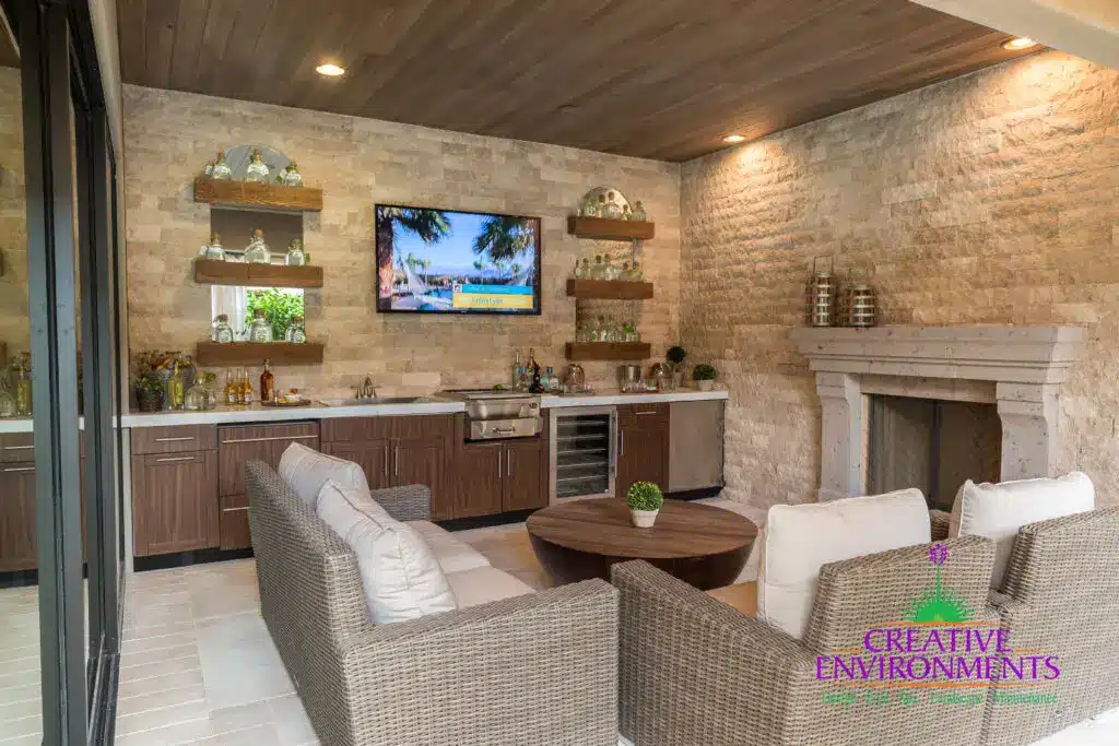 Custom backyard design with natural wood accents, fireplace and outdoor bar.