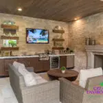 Custom backyard design with natural wood accents, fireplace and outdoor bar.