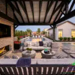 Custom backyard design with blue pool, Jesus steps and outdoor shade structure.
