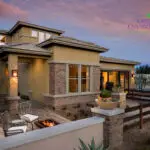 Custom front yard design with fire table, outdoor seating area and wok planters.