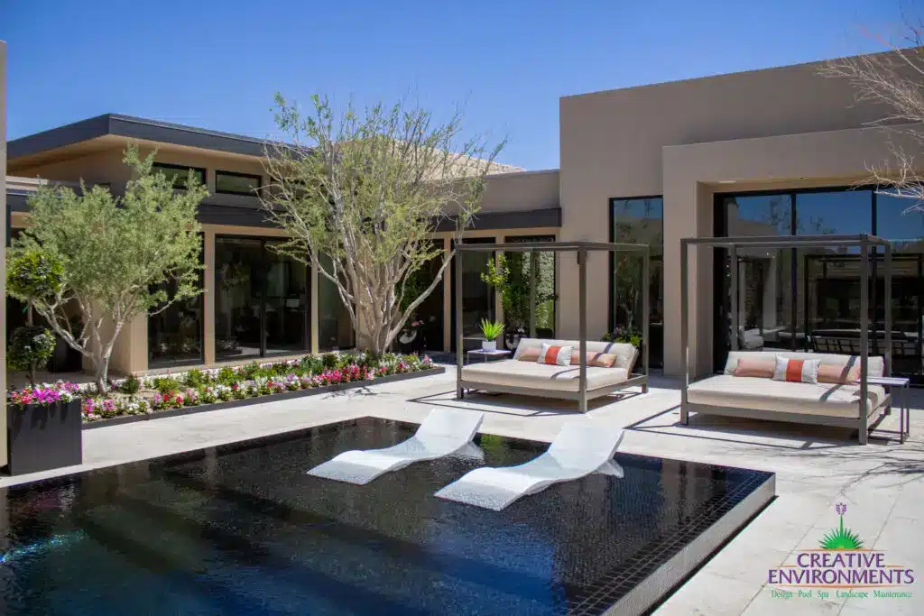 Custom backyard design with large baja step, cabanas and organized planting.