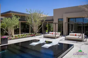 Custom backyard design with large baja step, cabanas and organized planting.