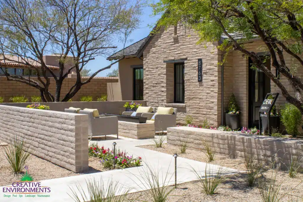 Custom entryway design with fire table, organized planting and privacy wall.