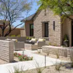 Custom entryway design with fire table, organized planting and privacy wall.