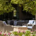 Custom backyard design with fire pit, multiple seating areas and annuals.