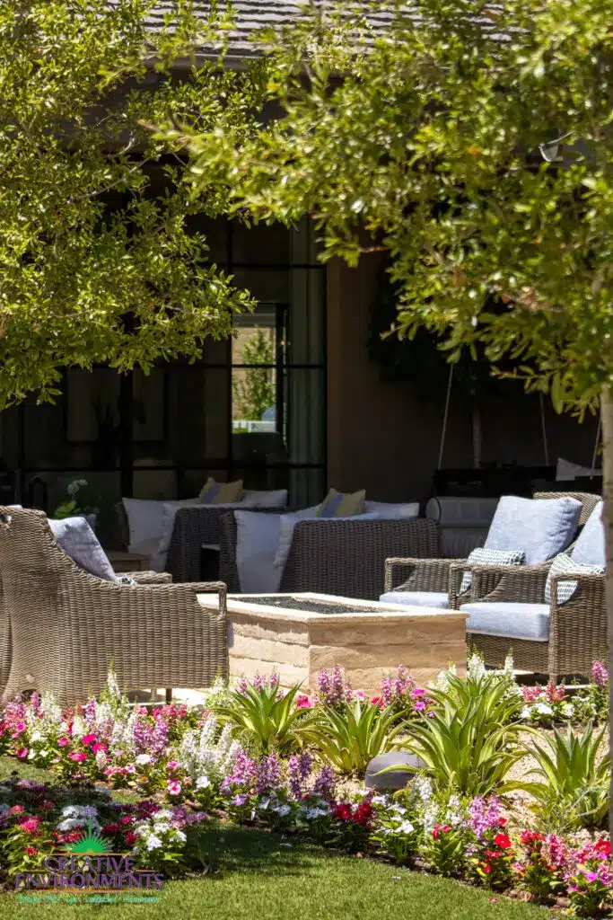 Custom backyard design with fire pit, multiple seating areas and annuals.