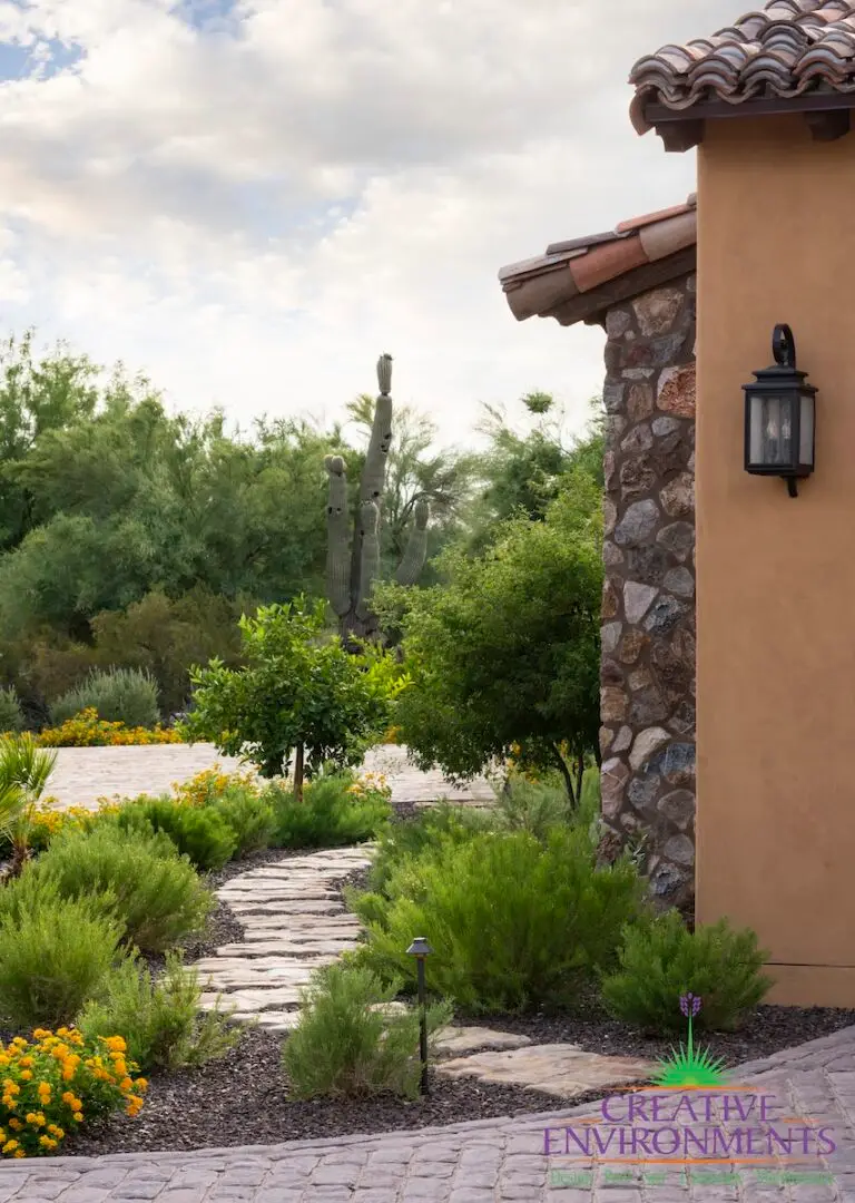 Front yard design with paver walkway and plants.