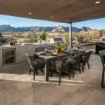 Custom backyard design with outdoor kitchen and recessed lighting