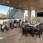 Custom backyard design with outdoor dining area and bar seating
