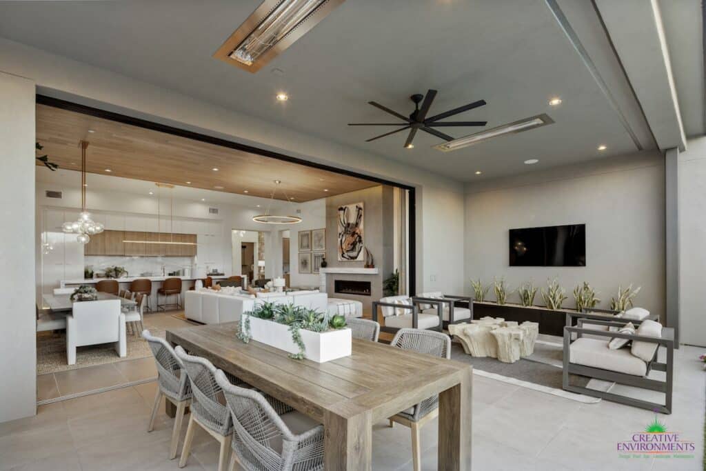 Custom backyard design with outdoor TV, multiple seating areas and outdoor fan.