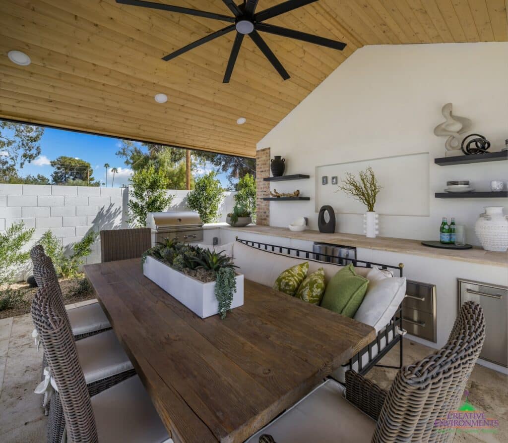 Custom backyard design with outdoor shade structure, built-in BBQ and recessed lighting.