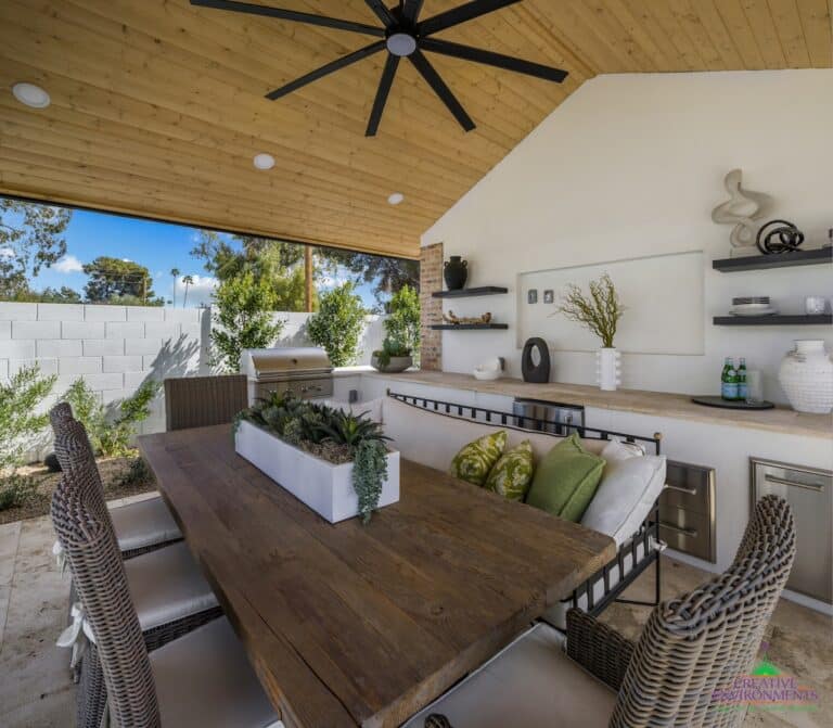 Custom backyard design with outdoor shade structure, built-in BBQ and recessed lighting.