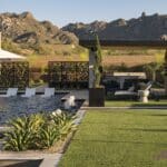 Custom backyard design with shade structure, custom metal dividers and large planters.