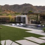 Custom backyard design with custom metal dividers, raised spa and large baja step.