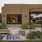 Custom backyard design with sunken fire pit, deco-tile flooring and pool.