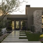 Custom backyard design with large planters, custom water feature and travertine steps.