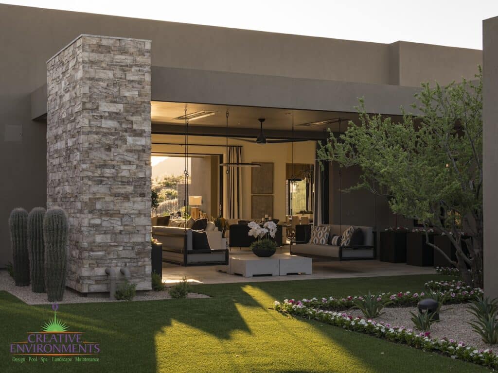 Custom front yard design with hanging beds, cacti and artificial turf.
