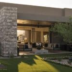 Custom front yard design with hanging beds, cacti and artificial turf.
