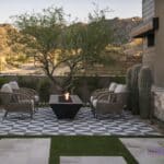 Custom front yard design with fire table, artificial grass and deco-tile flooring.