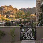 Custom front yard design with custom metal gate, topiaries and cacti.