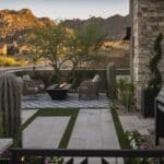 Custom front yard design with deco-tile flooring, fire table and cacti.
