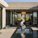 Custom backyard design with metal statement piece, zero-edge pool and succulents.