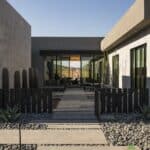 Custom front yard design with metal statement piece, metal fencing and cacti.