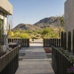 Custom front yard design with cacti, metal fencing and desert views.