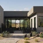 Custom front yard design with metal statement piece, succulents and metal fencing.