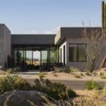 Custom front yard design with metal statement piece, Saguaro and desert plants.