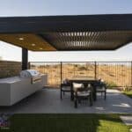 Custom backyard design with cantilevered shade structure, built-in BBQ and outdoor dining area.