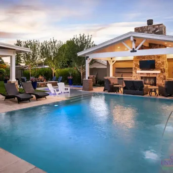 4737Pool(LOGO) Custom backyard design with zero-edge pool, farmhouse shade structure and water columns.