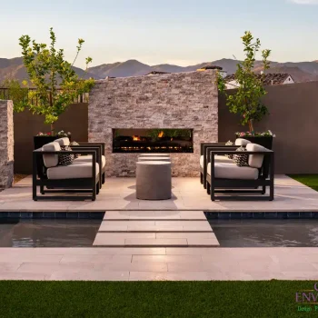 4978Patio(LOGO) Custom backyard with Jesus steps, angled fireplace and pool.