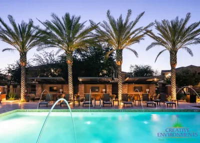 Custom community amenities with blue pool, water fountain feature into pool and multiple cantilevered shade structures.