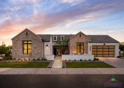 Custom front yard design with organized planting, real grass and unique front entryway.