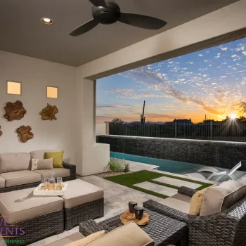 Blackstone Model 2 Patio Custom backyard design with natural stone paver teps, black water wall feature and metal fencing.
