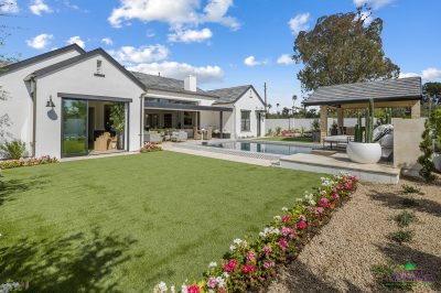 Custom backyard design with annuals, organized planting and topiaries.