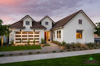 Custom front yard design with organized planting, brick paver walkway and large planters.