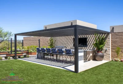 Custom backyard design with slatted metal shade structure, large planters and outdoor entertainment area.